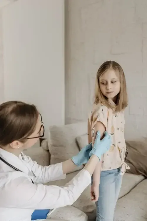 another doctor putting a bandaid on a girl, not the same one as before though